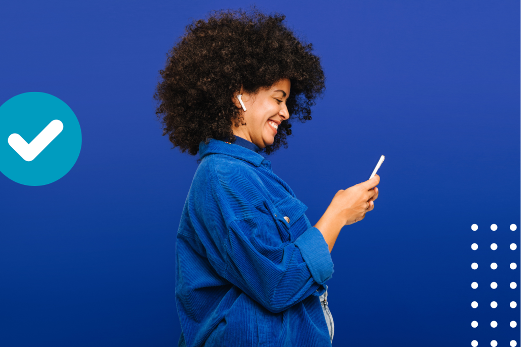 Woman smiling while using a smartphone to call Experts against a blue background, utilizing customized solutions perfectly suited to her business needs.