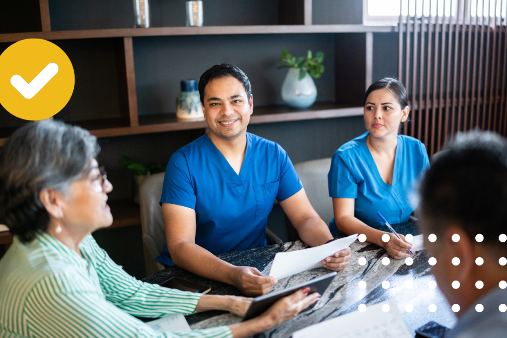 Healthcare professionals and medical receptionist services in a discussion with a patient, in a comfortable and supportive consultation environment.